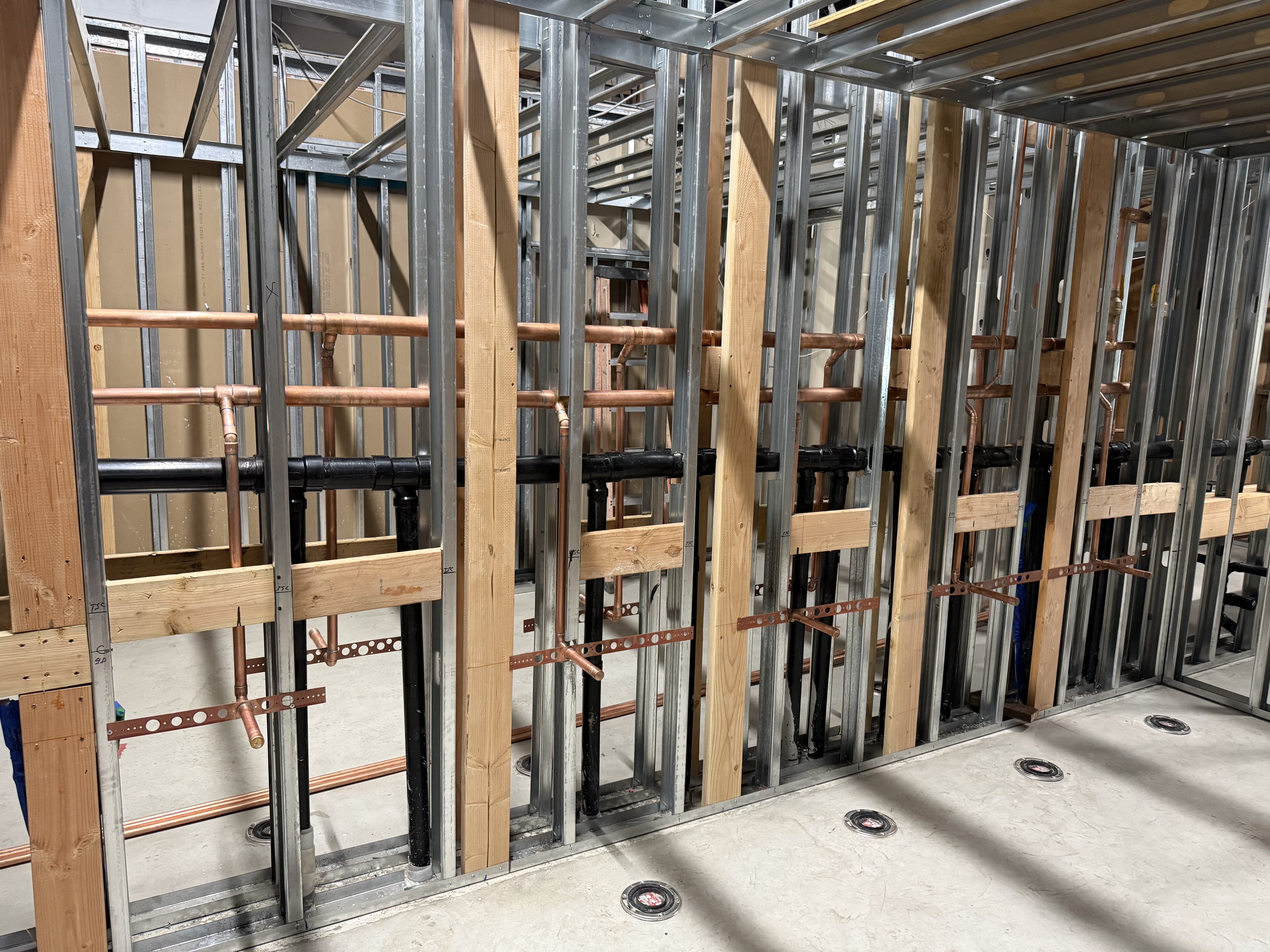 Commercial bathroom rough-in plumbing — drain and waste lines