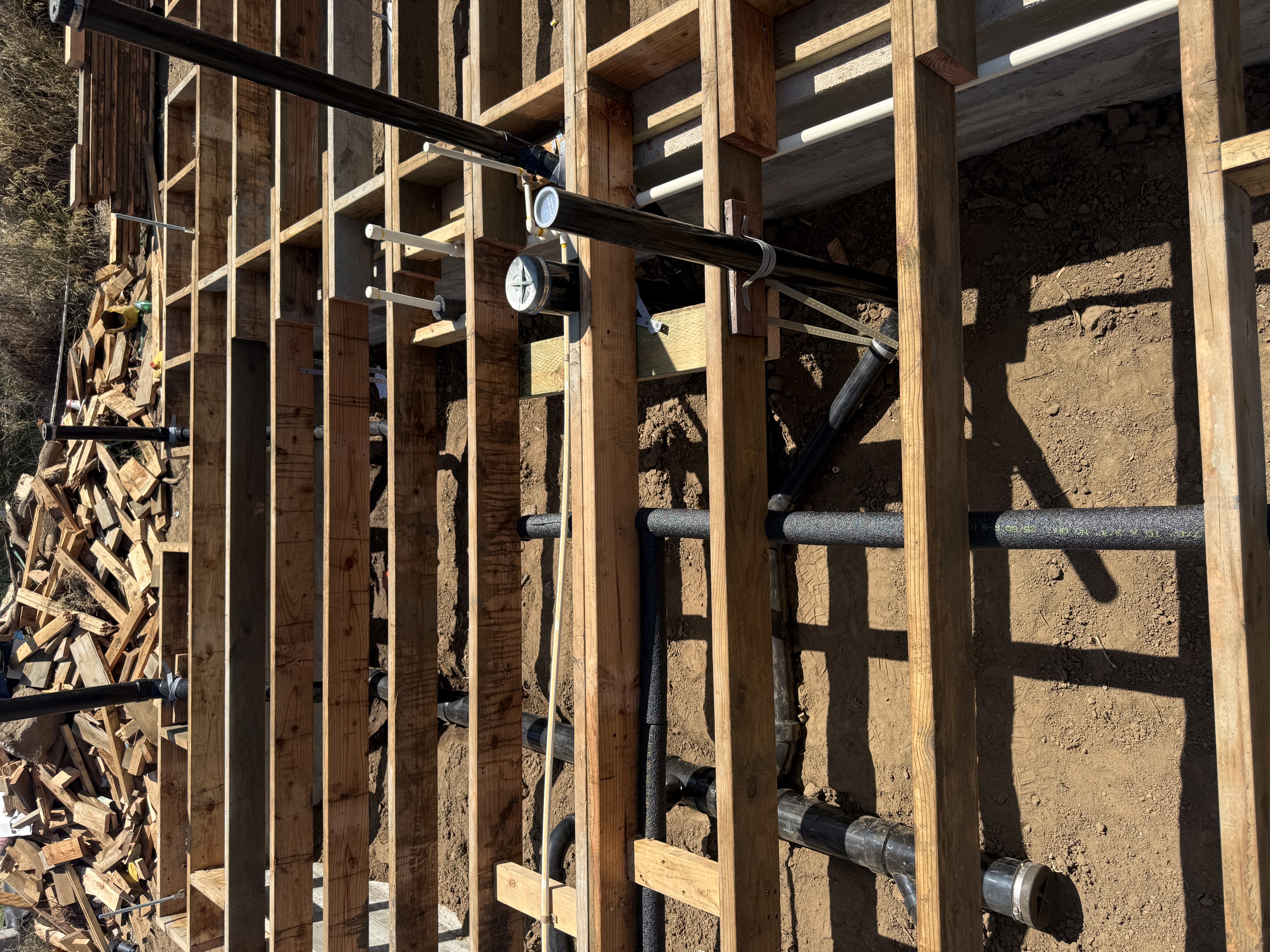 ABS drain lines and water lines routed through floor joists on new construction